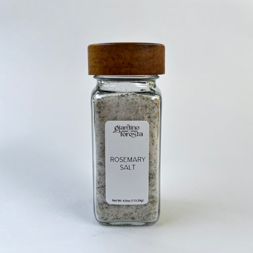 A square glass spice jar filled with seasoning salt, featuring a white label with the brand name 'Giardino Foresta' and a dark brown wooden lid, set against a white background.